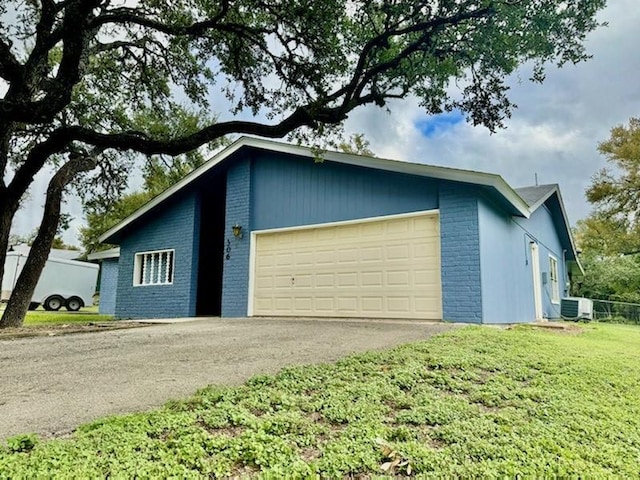 exterior space with central air condition unit and driveway