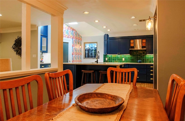 dining area featuring lofted ceiling and ornamental molding