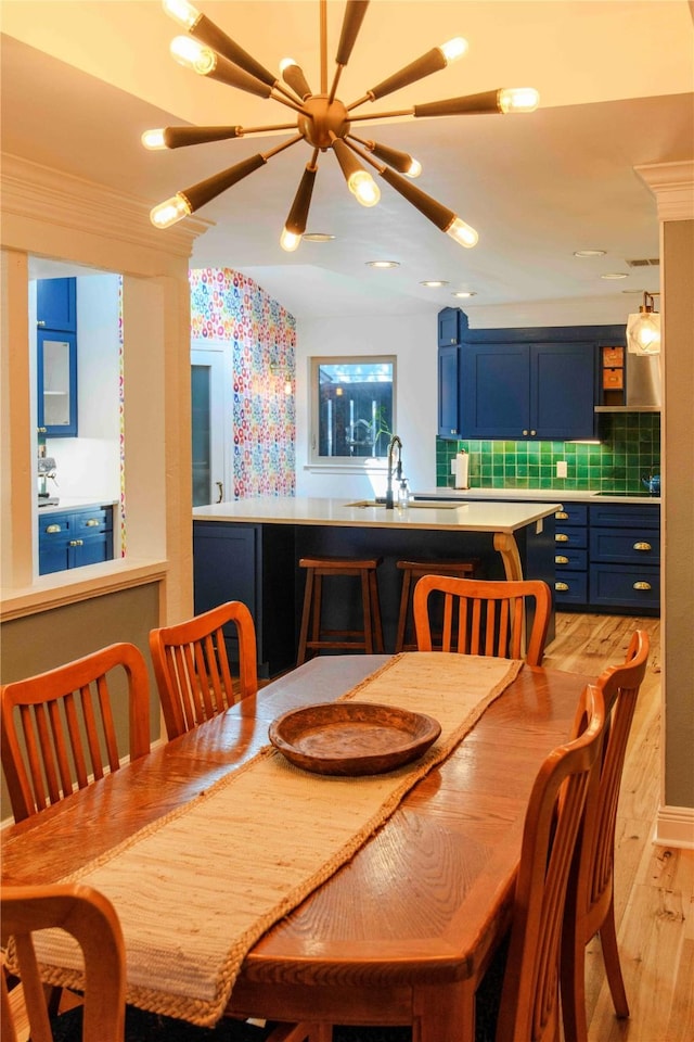 dining area with sink and light hardwood / wood-style floors