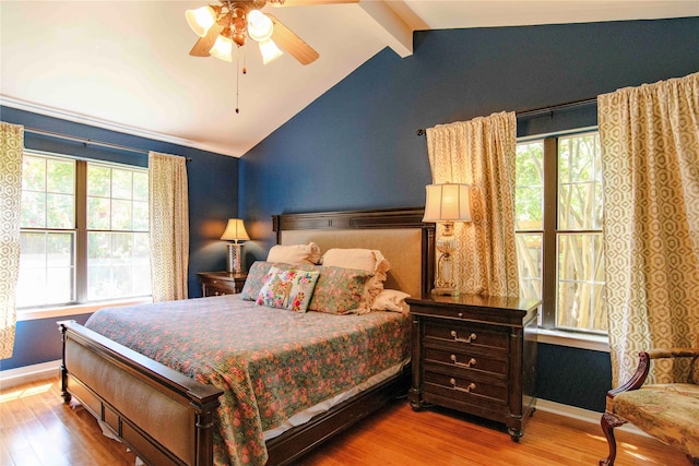 bedroom with ceiling fan, wood-type flooring, and vaulted ceiling with beams