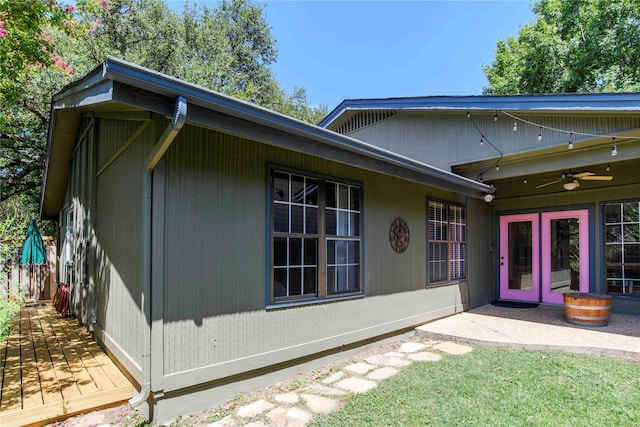 rear view of house with ceiling fan and french doors