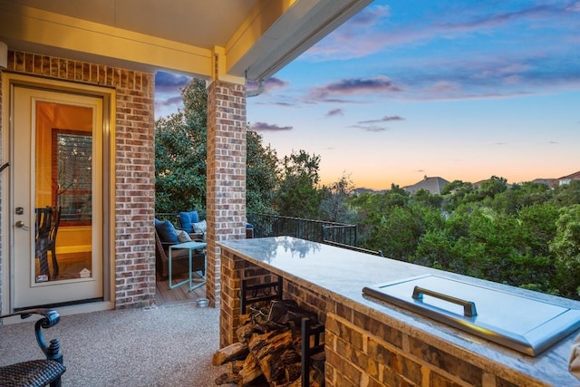 patio terrace at dusk featuring a bar