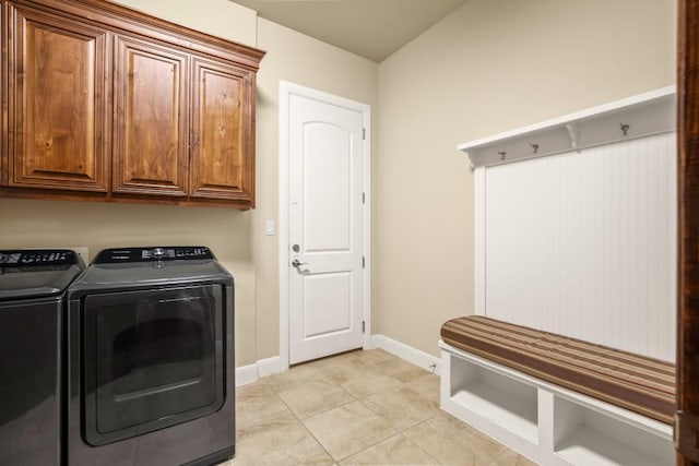 laundry room with baseboards, cabinet space, and washing machine and clothes dryer