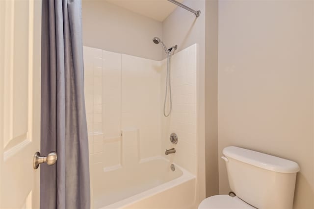 bathroom with shower / bath combo with shower curtain and toilet