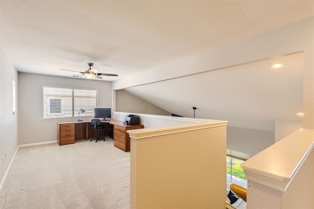 carpeted office space with a textured ceiling, ceiling fan, and lofted ceiling