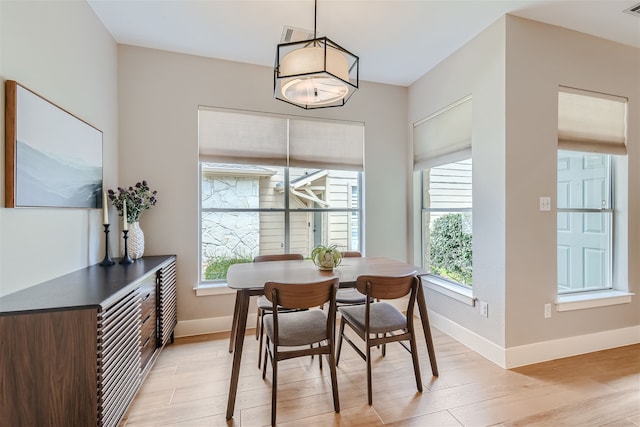 dining space featuring light wood-type flooring