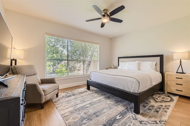 bedroom with ceiling fan and light hardwood / wood-style floors