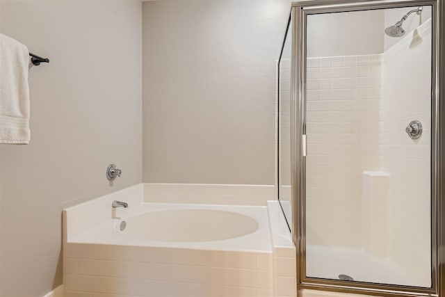 bathroom with shower with separate bathtub