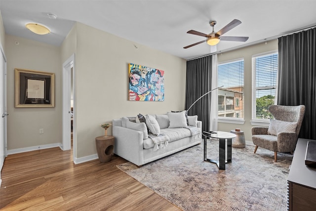 living room featuring ceiling fan and wood-type flooring