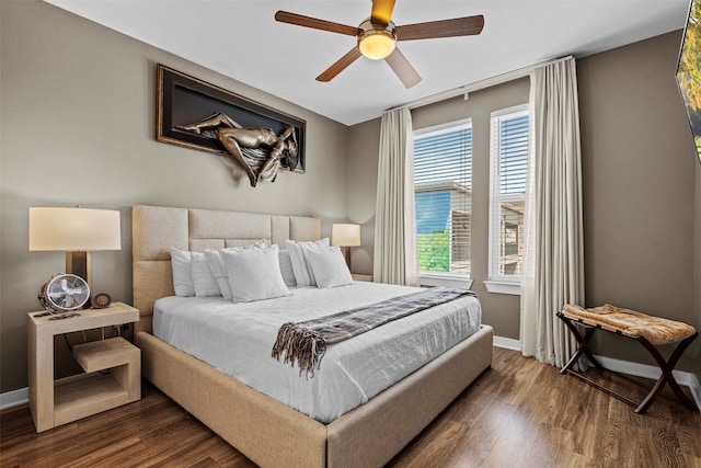 bedroom with ceiling fan, multiple windows, and hardwood / wood-style flooring