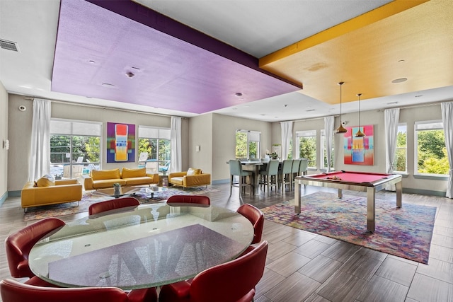 rec room with plenty of natural light, a tray ceiling, and billiards