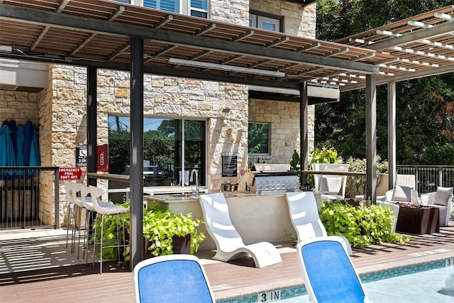 view of patio featuring a pergola and a wooden deck