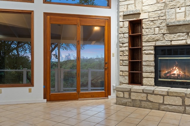 room details featuring a stone fireplace and tile patterned flooring