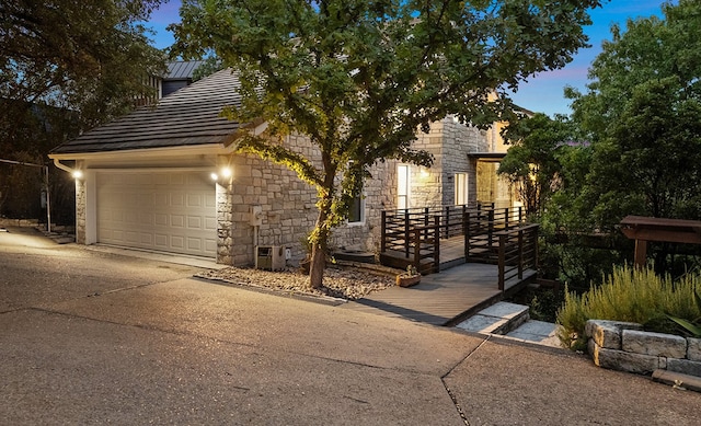 property exterior at dusk featuring a garage