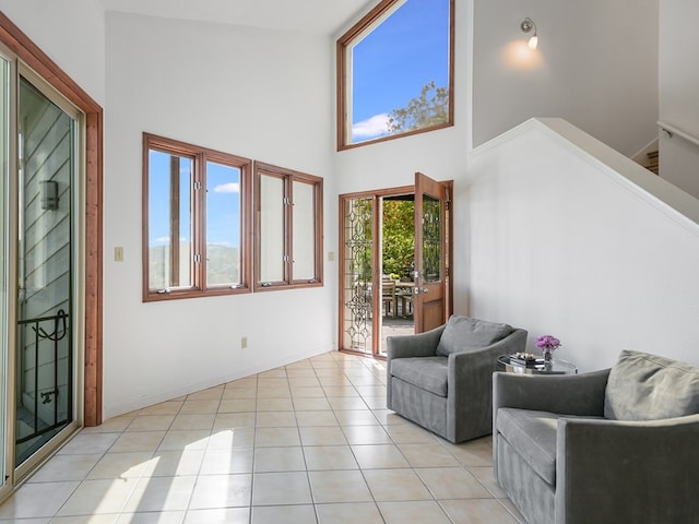 interior space featuring high vaulted ceiling and light tile patterned floors