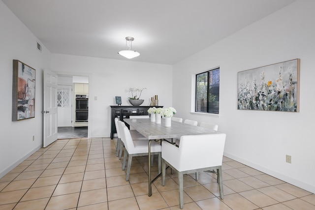 dining space with light tile patterned floors