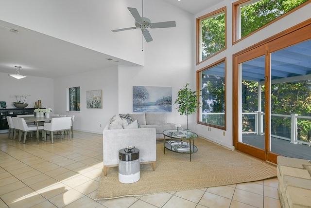 living room featuring high vaulted ceiling, light tile patterned floors, ceiling fan, and plenty of natural light