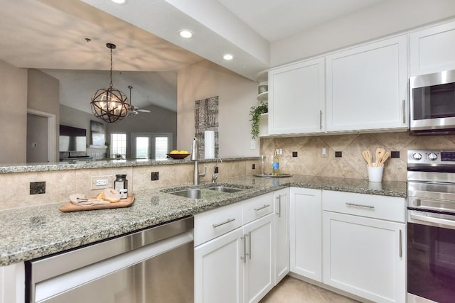 kitchen with backsplash, stainless steel appliances, and white cabinets