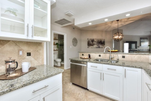 kitchen with sink, dishwasher, pendant lighting, light stone countertops, and white cabinets