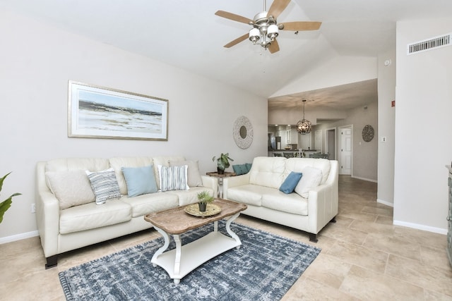 living room featuring ceiling fan with notable chandelier and high vaulted ceiling