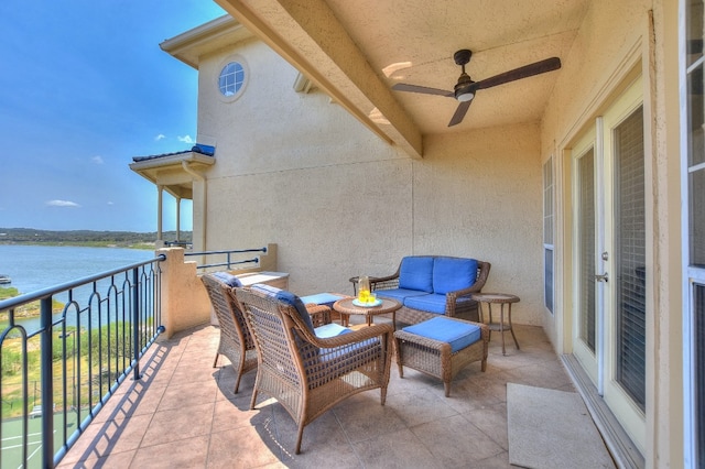 balcony featuring a water view and ceiling fan