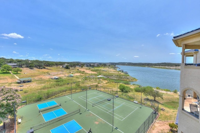 view of tennis court with a water view