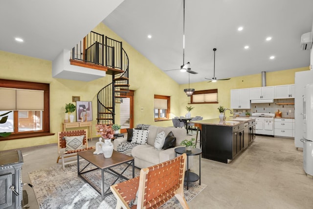 living room featuring sink, ceiling fan, and high vaulted ceiling