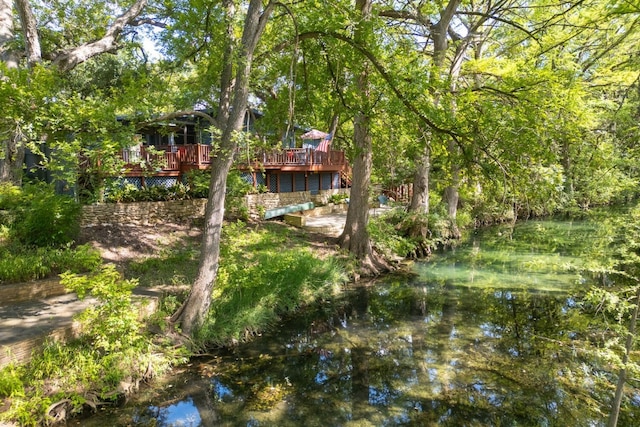 view of yard featuring a deck with water view