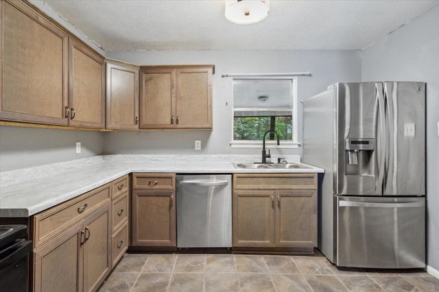 kitchen with sink, light tile patterned flooring, and stainless steel appliances