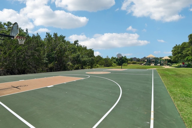 view of sport court with a playground and a lawn