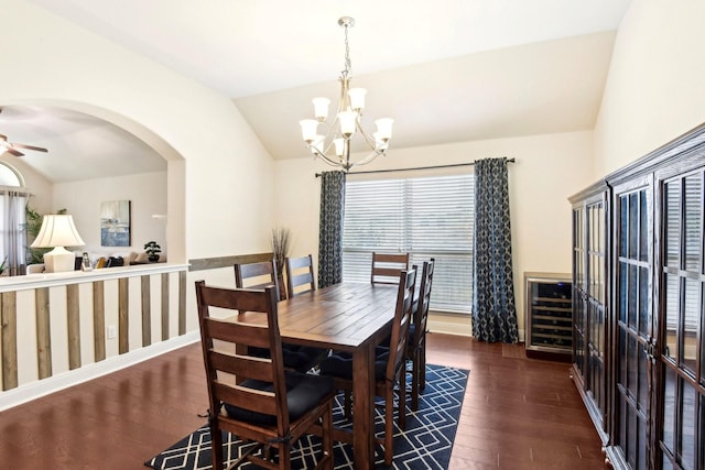 dining room with beverage cooler, lofted ceiling, ceiling fan with notable chandelier, and dark hardwood / wood-style floors