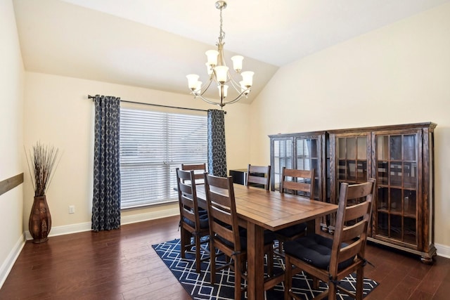 dining room featuring vaulted ceiling, a chandelier, and dark hardwood / wood-style flooring