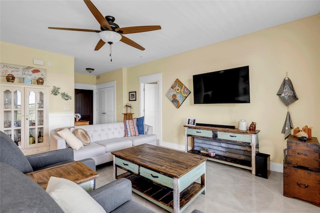 tiled living room featuring ceiling fan