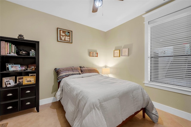 bedroom with ceiling fan and light tile patterned floors