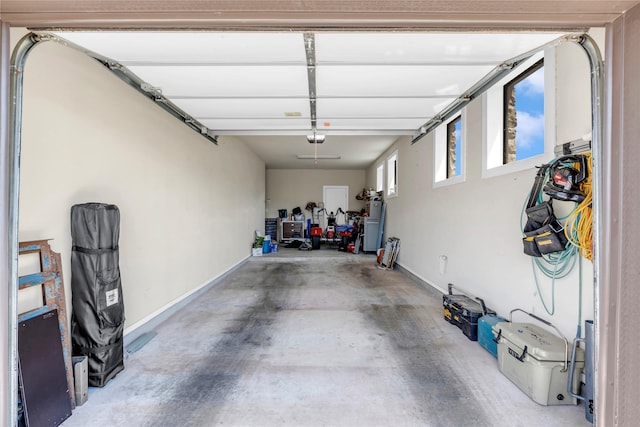 garage featuring a garage door opener and water heater