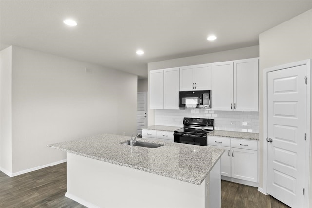 kitchen featuring white cabinets, a kitchen island with sink, sink, and black appliances