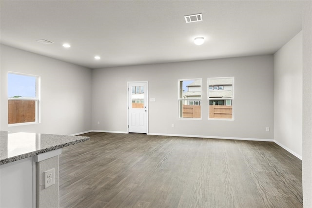 unfurnished living room featuring dark hardwood / wood-style flooring