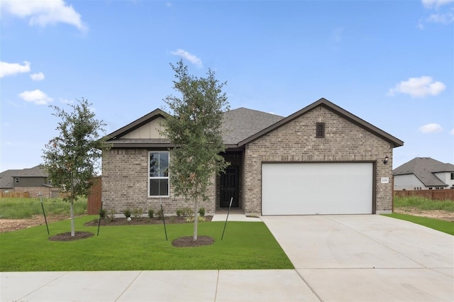 view of front of house featuring a garage and a front yard