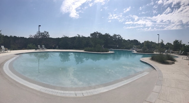 view of swimming pool featuring a patio area