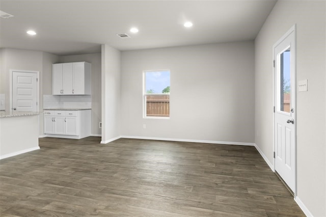 unfurnished living room featuring dark wood-type flooring