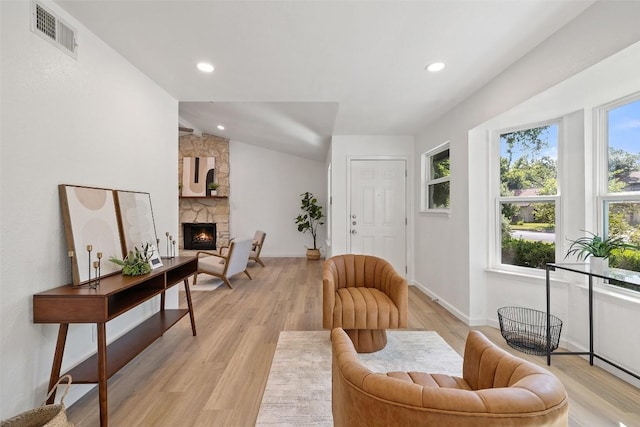 11506 Fence Post Trl, Austin, TX 78750 - living area featuring healthy amount of natural light, a stone fireplace, light wood-style floors, recessed lighting, and lofted ceiling