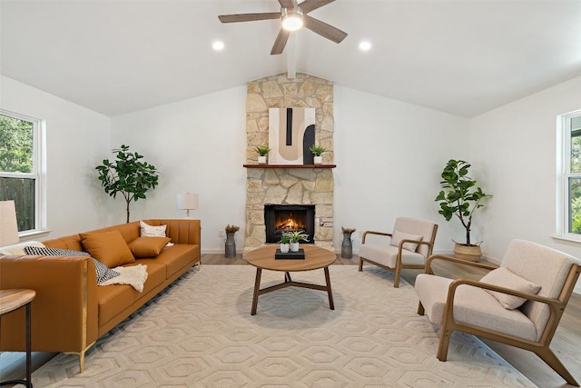 11506 Fence Post Trl, Austin, TX 78750 - living area featuring plenty of natural light, a ceiling fan, a stone fireplace, and light wood-type flooring