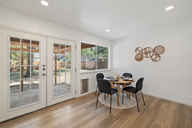 dining room featuring light hardwood / wood-style flooring and french doors