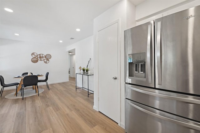 11506 Fence Post Trl, Austin, TX 78750 - kitchen with stainless steel fridge, light wood finished floors, recessed lighting, baseboards, and white cabinets