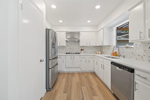11506 Fence Post Trl, Austin, TX 78750 - kitchen with stainless steel appliances, wall chimney exhaust hood, a sink, white cabinetry, and tasteful backsplash