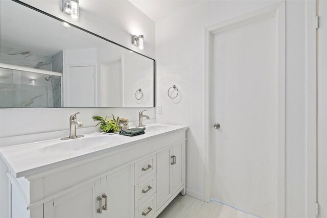 bathroom with vanity and a shower with shower door