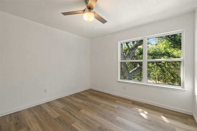 empty room with light wood-type flooring and ceiling fan