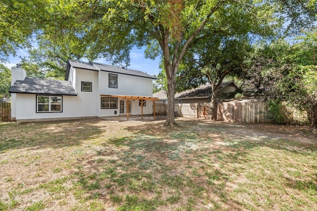 back of property featuring a lawn