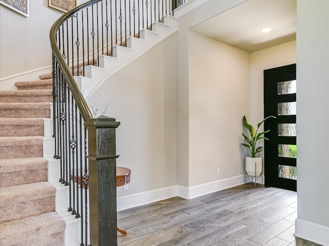 stairway with hardwood / wood-style flooring