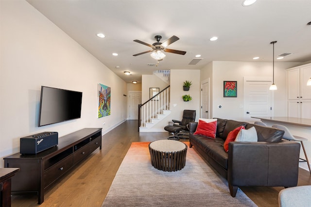 living room with ceiling fan and light wood-type flooring